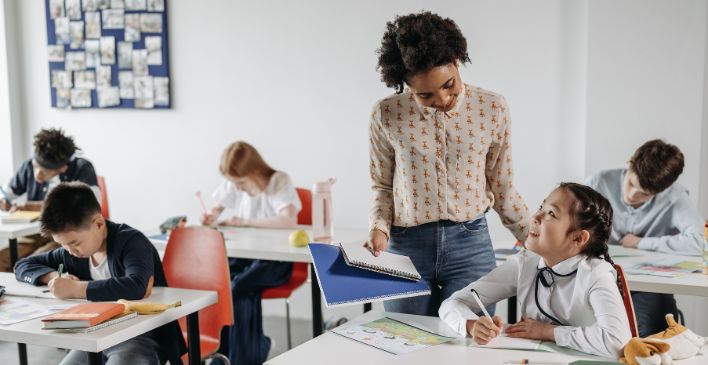 Teacher in a classroom, helping her students